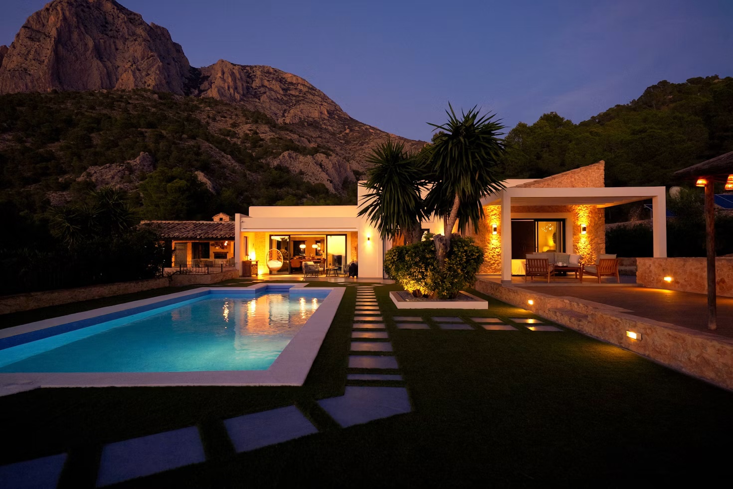 Estate pool at dusk with mountain view